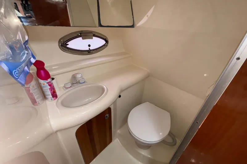 Slide: The Image of 2007 Maxum 2600 SE boat bathroom with sink, toilet, and toiletries. - 13