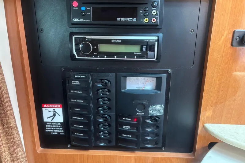 Slide: The Image of Electrical control panel in a 2007 Maxum 2600 SE boat with Kenwood stereo system. - 15