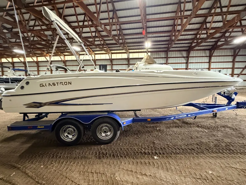 Slide: The Image of 2003 Glastron DX215 deck boat with 220HP Volvo/Penta engine on a tandem axle trailer. - 22