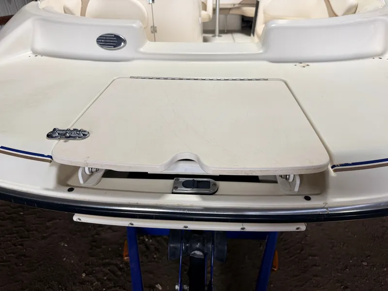 Slide: The Image of The image shows the deck of a Glastron DX215 boat with a hatch. - 11