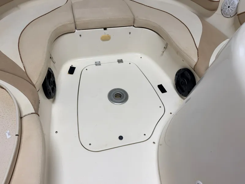 Slide: The Image of Interior view of a Glastron DX215 deck boat with beige cushions and speakers. - 13