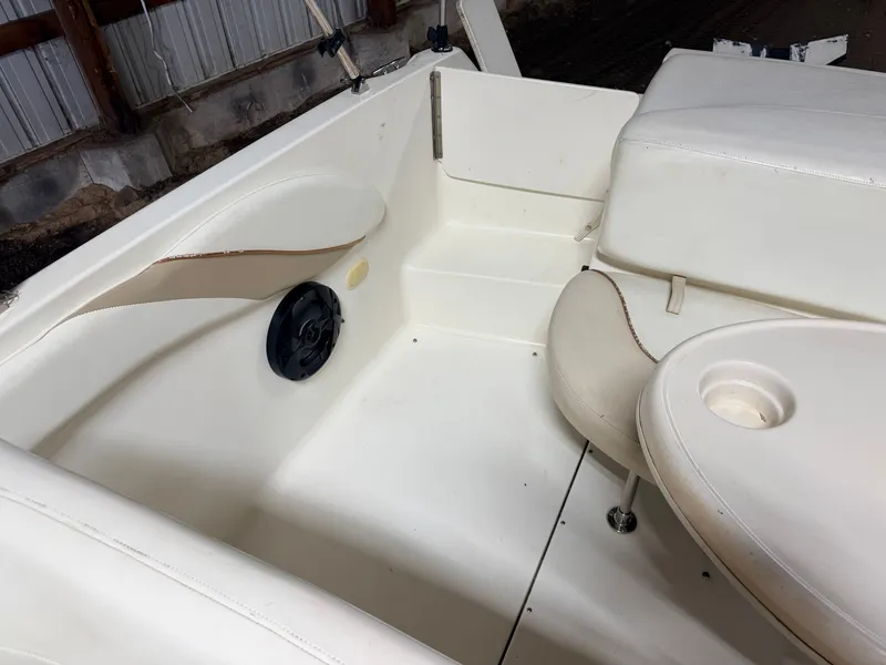 Slide: The Image of Interior of a Glastron DX215 deck boat with white upholstery and speaker. - 45