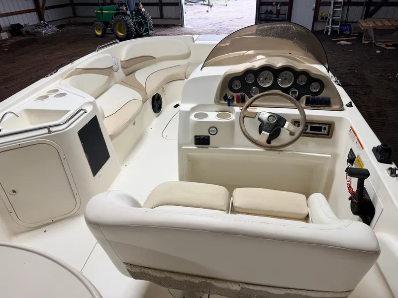Slide: The Image of Interior view of a Glastron DX215 deck boat with helm and seating area. - 6