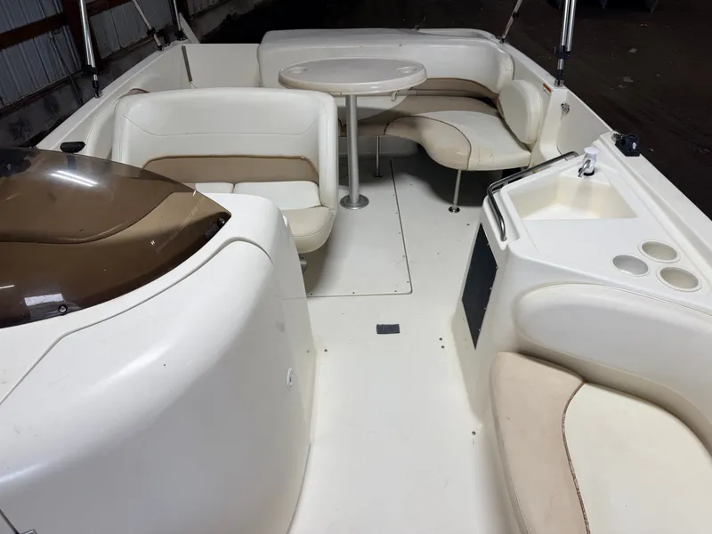 Slide: The Image of Interior view of a Glastron DX215 deck boat with seating area and table. - 5