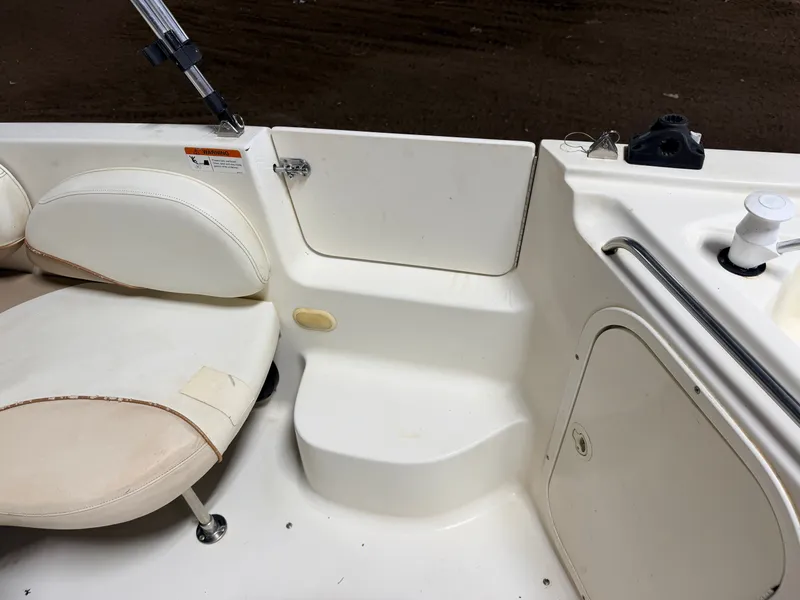 Slide: The Image of Interior view of a boat with white seating and steps. - 36