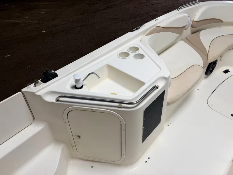 Slide: The Image of The image shows the deck of a Glastron DX215 boat with a small sink and seating area. - 33