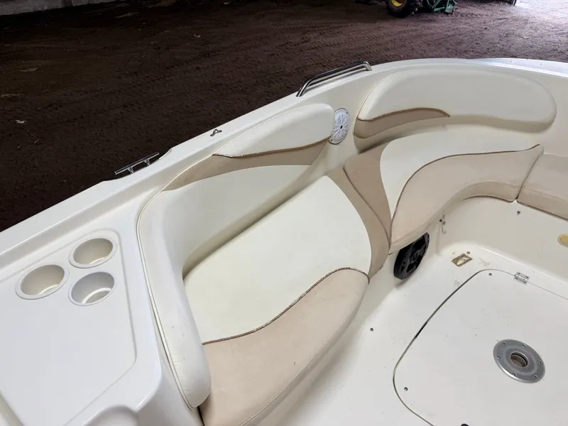 Slide: The Image of Interior view of a Glastron DX215 deck boat with beige and white seating. - 16