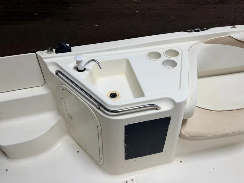 Slide: The Image of A white boat with a built-in sink and cup holders on the deck. - 34