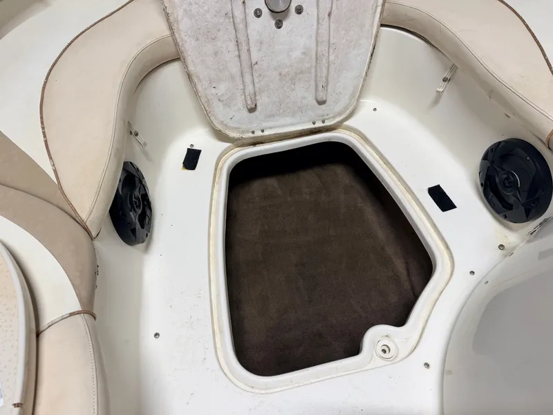 Slide: The Image of Open storage compartment in the bow of a boat with speakers and cushioned seating. - 14
