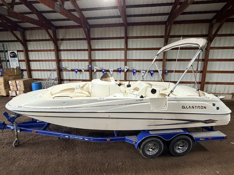 Slide: The Image of 2003 Glastron DX215 deck boat with 220HP Volvo/Penta engine and tandem axle trailer. - 4