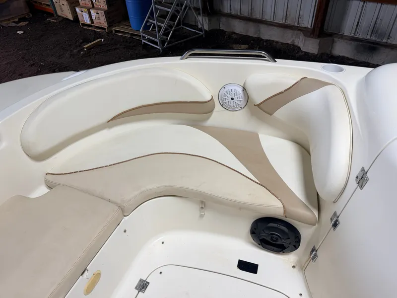 Slide: The Image of Interior view of a Glastron DX215 deck boat with white and beige seating. - 21