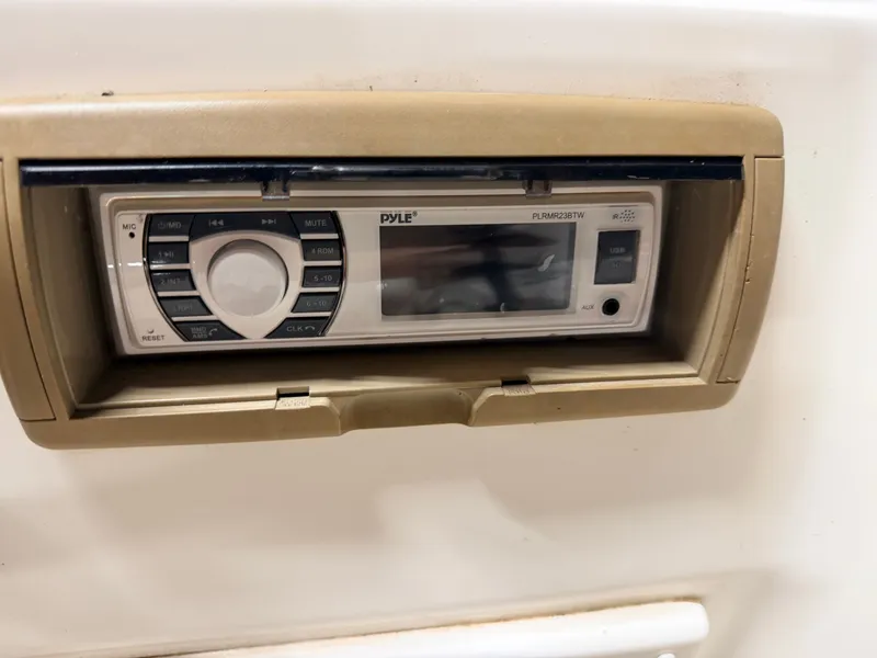 Slide: The Image of Close-up of a built-in boat radio with controls and display. - 30