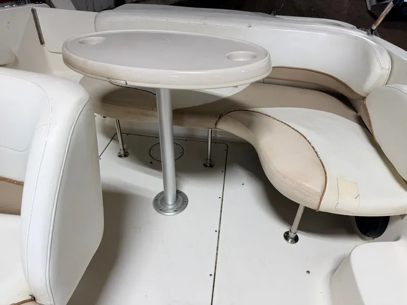 Slide: The Image of Interior view of a boat with white seating and a round table. - 46