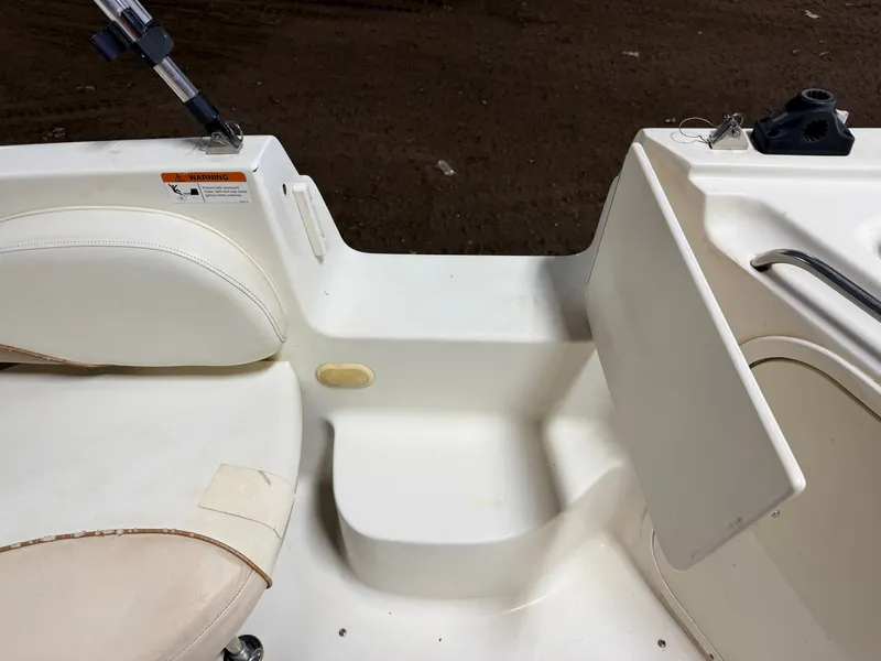 Slide: The Image of Close-up of a boat deck with white seating and a small table. - 37