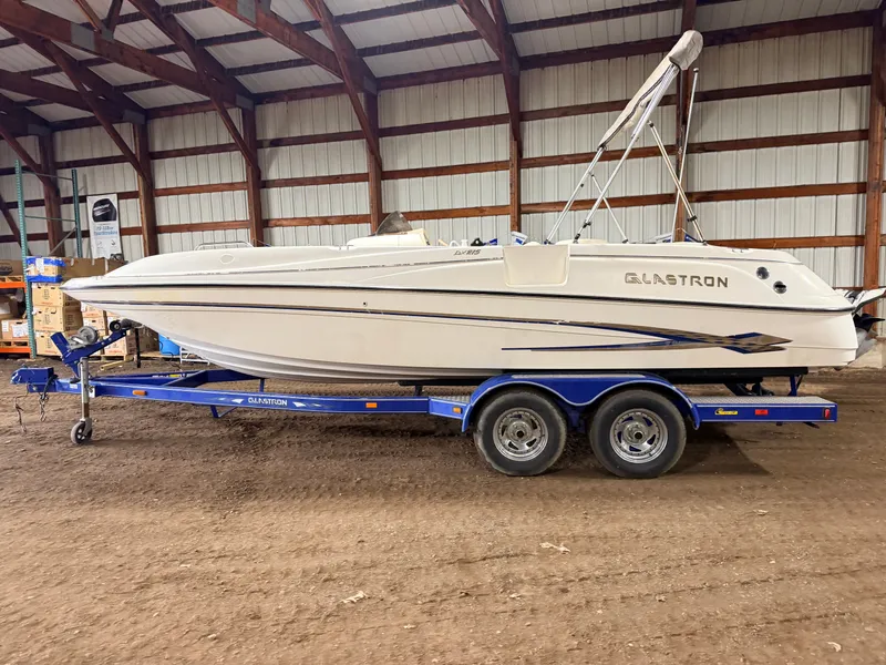 Slide: The Image of 2003 Glastron DX215 deck boat with 220HP Volvo/Penta engine on a tandem axle trailer. - 31