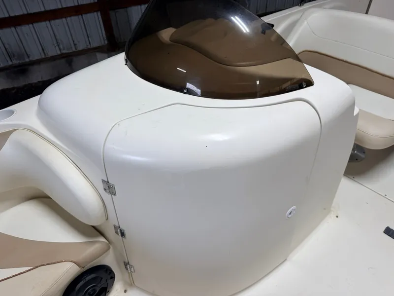 Slide: The Image of Close-up of the white helm station on a Glastron DX215 deck boat. - 24