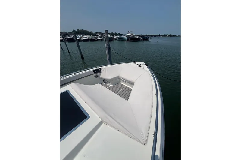 Slide: The Image of 2019 Formula 430 Super Sport Crossover boat docked in a marina, showcasing sleek design. - 74