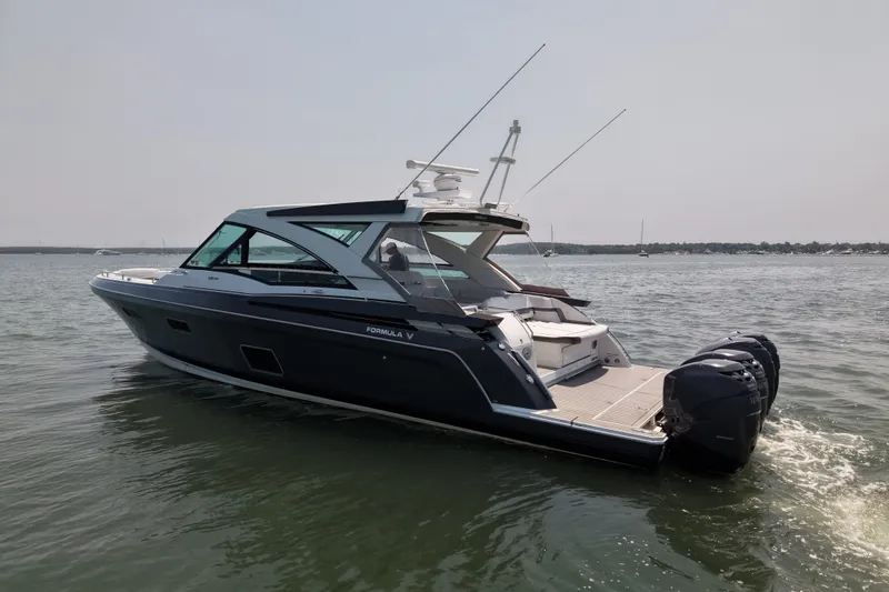 Slide: The Image of 2019 Formula 430 Super Sport Crossover boat cruising on calm waters. - 8