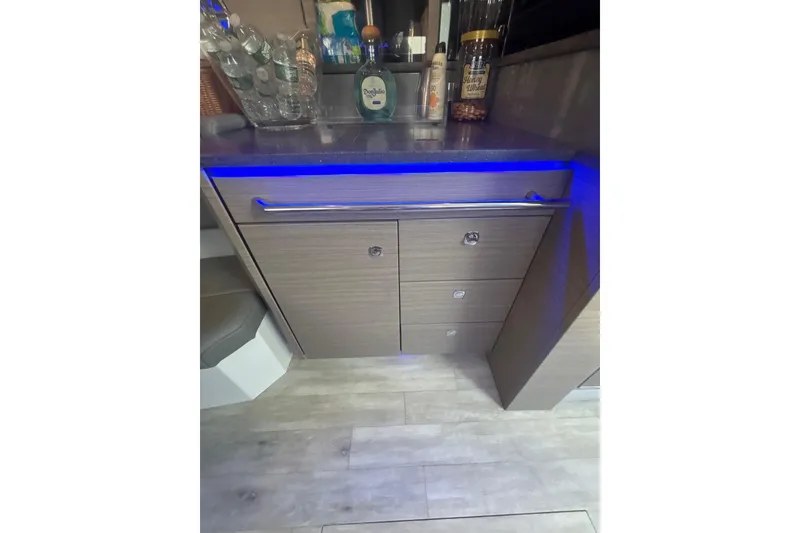 Slide: The Image of 2019 Formula 430 Super Sport Crossover interior with modern cabinetry and blue LED lighting. - 65