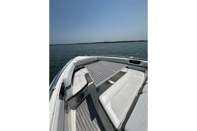 Slide: The Image of 2019 Formula 430 Super Sport Crossover boat interior with seating and table on open water. - 48