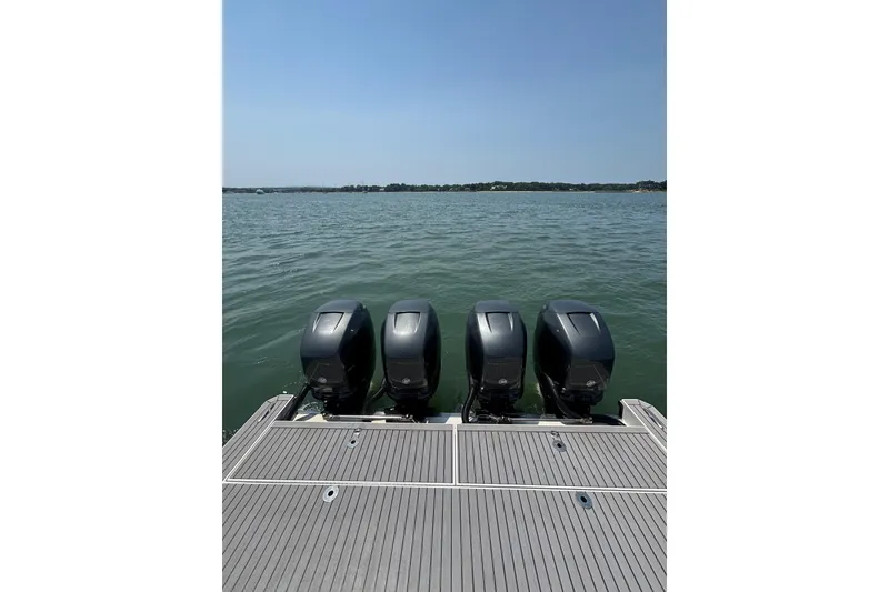 Slide: The Image of 2019 Formula 430 Super Sport Crossover with four powerful outboard engines on a calm lake. - 28