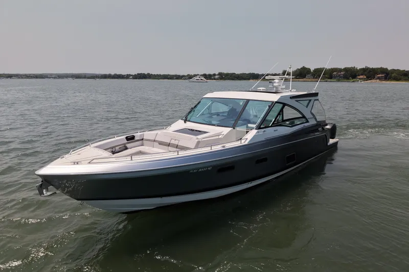 Slide: The Image of 2019 Formula 430 Super Sport Crossover boat cruising on a calm lake. - 25