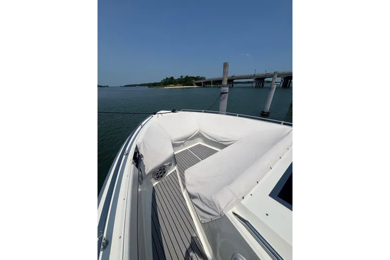 Slide: The Image of 2019 Formula 430 Super Sport Crossover boat docked near a bridge on a sunny day. - 75