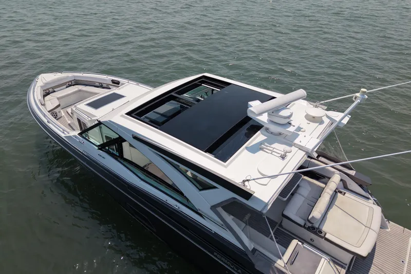 Slide: The Image of 2019 Formula 430 Super Sport Crossover yacht on water, showcasing sleek design and spacious deck. - 26