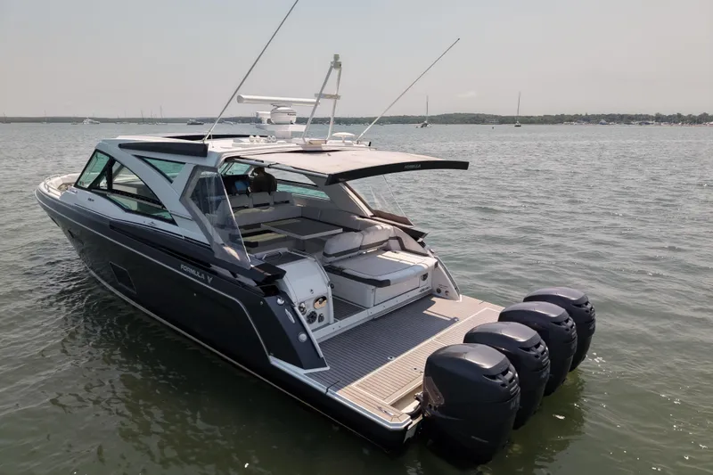 Slide: The Image of 2019 Formula 430 Super Sport Crossover boat on water, featuring sleek design and powerful engines. - 22