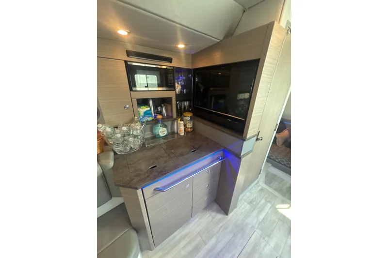 Slide: The Image of Interior of 2019 Formula 430 Super Sport Crossover with modern kitchenette and sleek cabinetry. - 63