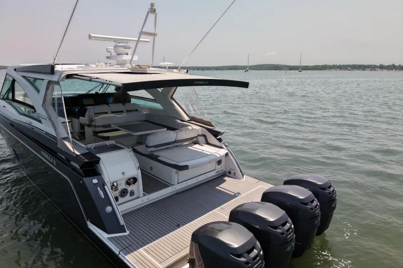 Slide: The Image of 2019 Formula 430 Super Sport Crossover yacht on calm water with multiple outboard engines. - 20