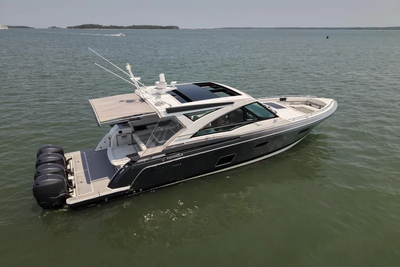 Slide: The Image of 2019 Formula 430 Super Sport Crossover boat on calm water, showcasing sleek design and powerful engines. - 19