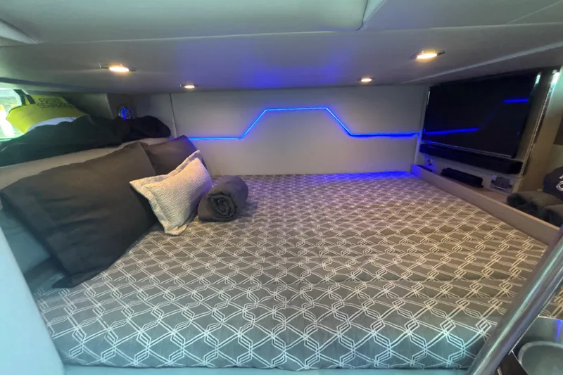 Slide: The Image of 2019 Formula 430 Super Sport Crossover cabin with modern bedding and ambient lighting. - 68