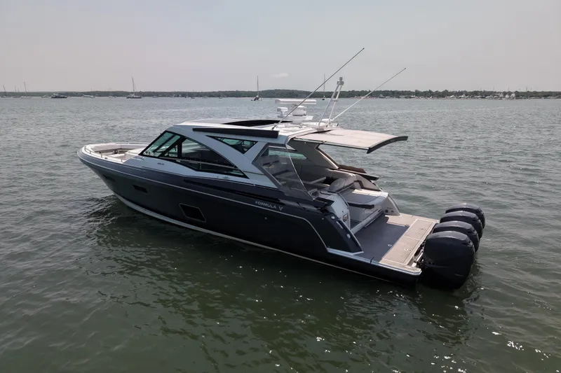 Slide: The Image of 2019 Formula 430 Super Sport Crossover boat on calm water, featuring sleek design and powerful engines. - 80