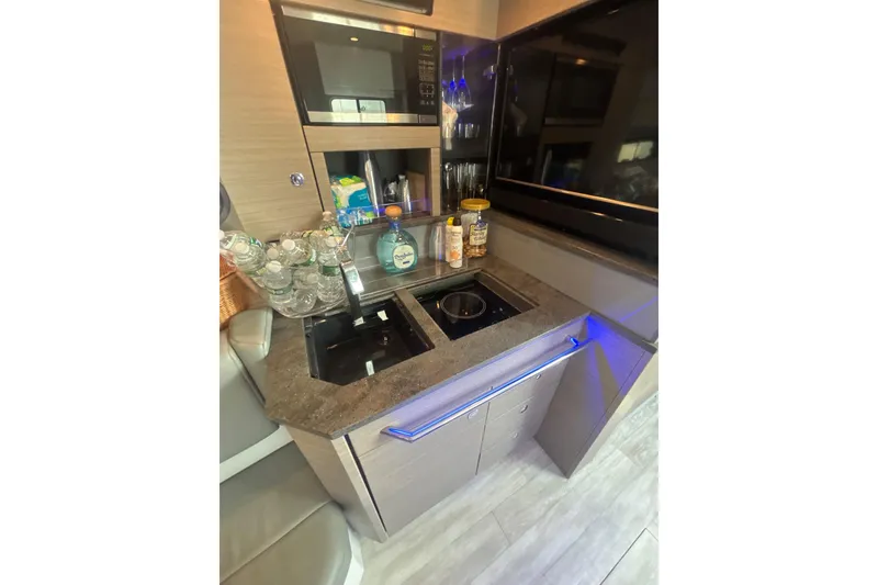 Slide: The Image of Compact kitchen area in a 2019 Formula 430 Super Sport Crossover boat. - 64