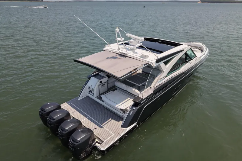 Slide: The Image of 2019 Formula 430 Super Sport Crossover boat on calm water, featuring multiple outboard engines. - 7