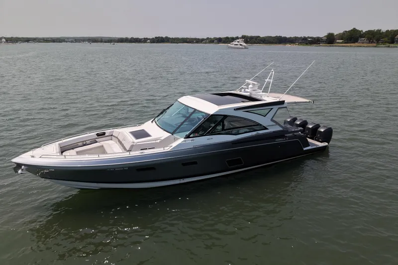 Slide: The Image of 2019 Formula 430 Super Sport Crossover boat on calm water, showcasing sleek design and luxury features. - 4
