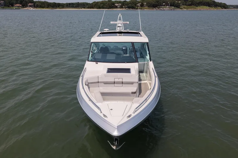 Slide: The Image of 2019 Formula 430 Super Sport Crossover boat on calm water, front view. - 11
