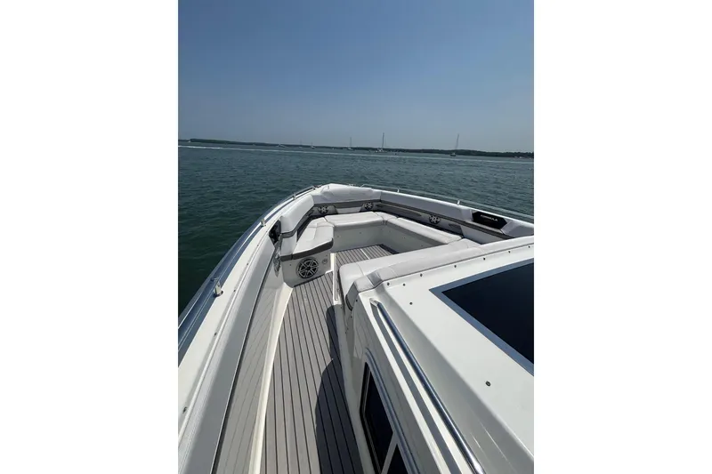 Slide: The Image of 2019 Formula 430 Super Sport Crossover boat on calm water, featuring spacious deck seating. - 46