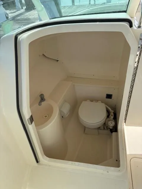Slide: The Image of The image shows a compact boat toilet with a sink and toilet. - 6