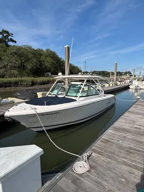 Slide: The Image of A white boat docked at a wooden pier, with a blue sky in the background. - 3