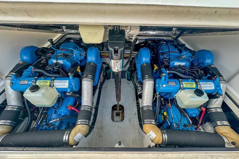 Slide: The Image of Engine compartment of a 2001 Tiara Yachts 2900 Coronet, featuring dual blue engines. - 27