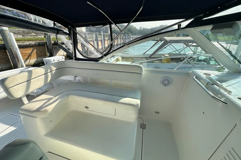 Slide: The Image of 2001 Tiara Yachts 2900 Coronet interior with white seating and waterfront view. - 25