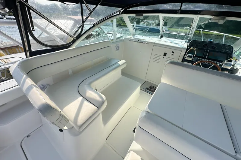 Slide: The Image of Interior of a 2001 Tiara Yachts 2900 Coronet, featuring white seating and helm. - 17