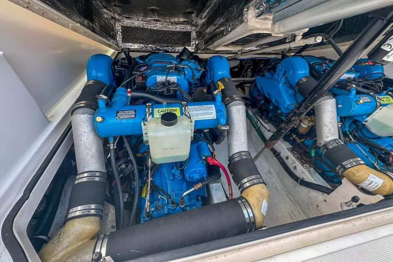 Slide: The Image of Engine compartment of a 2001 Tiara Yachts 2900 Coronet, showcasing dual blue marine engines. - 26