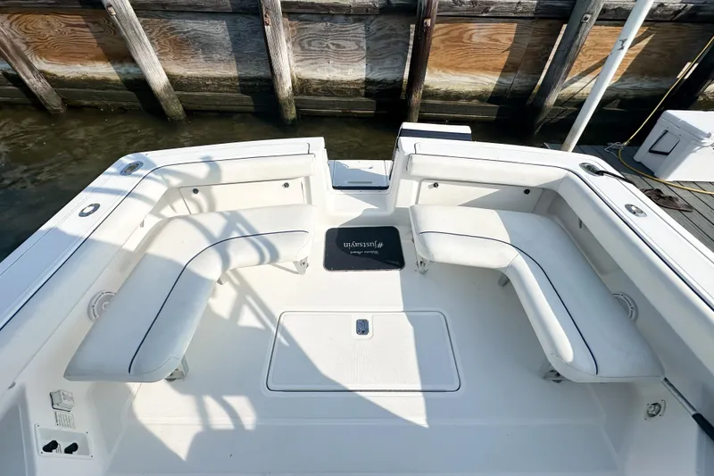 Slide: The Image of 2001 Tiara Yachts 2900 Coronet boat deck with white seating and dock background. - 14
