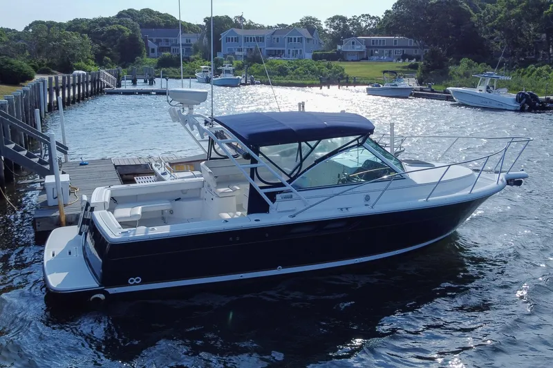 Slide: The Image of 2001 Tiara Yachts 2900 Coronet docked in a scenic marina setting. - 3