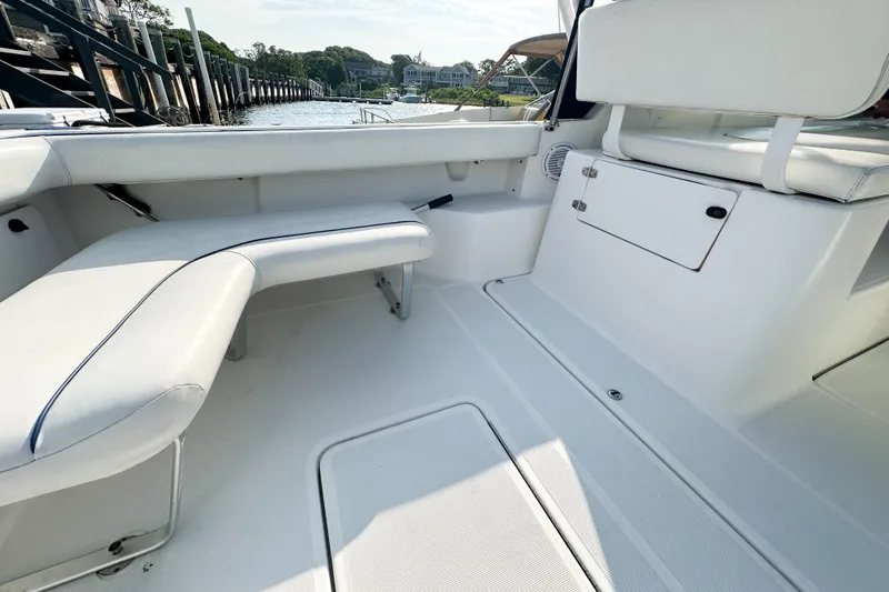 Slide: The Image of 2001 Tiara Yachts 2900 Coronet interior with white seating and storage compartments. - 15