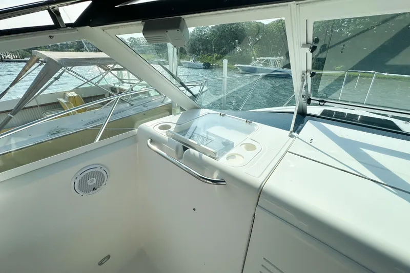Slide: The Image of 2001 Tiara Yachts 2900 Coronet cockpit with helm, cup holders, and scenic water view. - 19