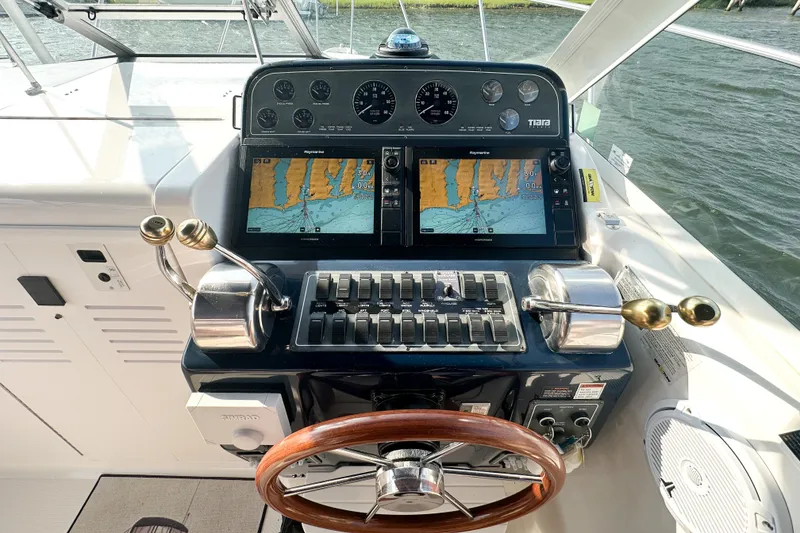 Slide: The Image of Helm of 2001 Tiara Yachts 2900 Coronet with navigation screens and controls. - 8
